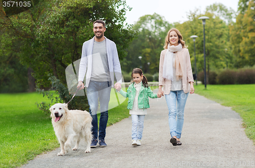 Image of happy family with labrador retriever dog in park