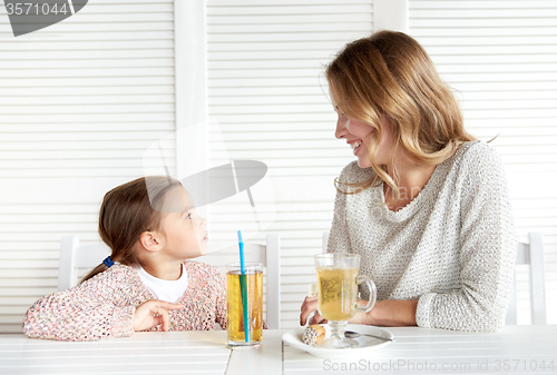 Image of happy family having dinner at restaurant or cafe