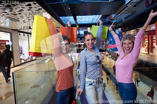 Image of happy young girls in  shopping mall