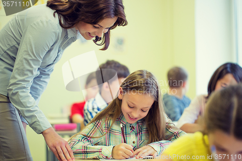 Image of group of school kids writing test in classroom