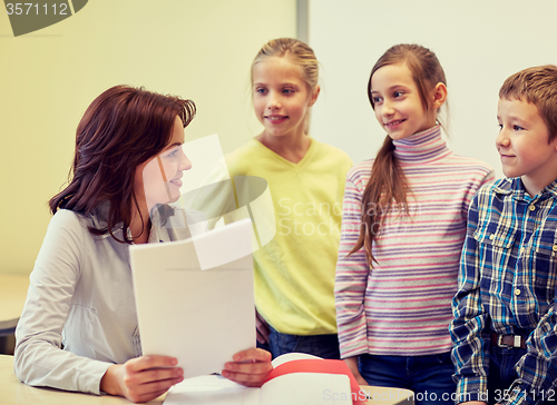 Image of group of school kids with teacher in classroom