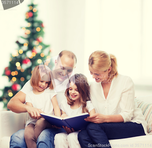 Image of happy family with book at home