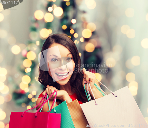 Image of smiling woman with colorful shopping bags