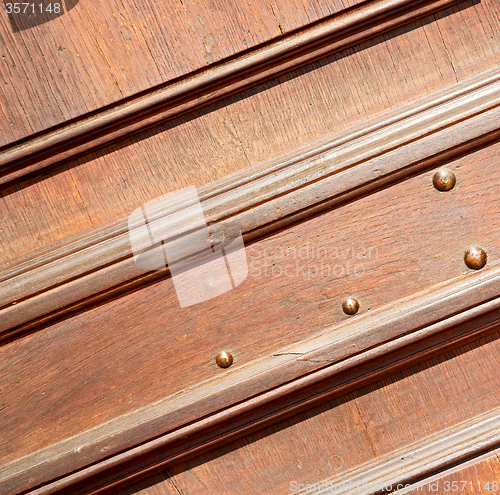 Image of door    in italy old ancian wood and traditional  texture nail
