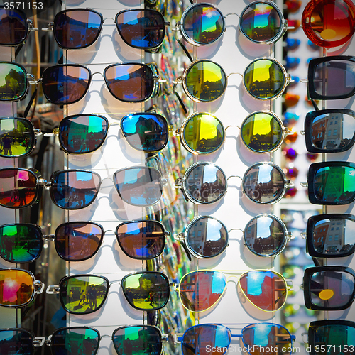 Image of in london glass and sunglasses in the light and reflex