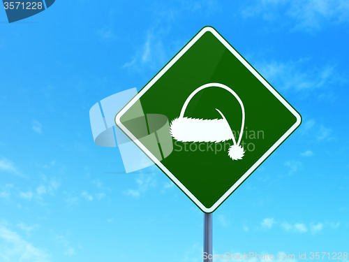 Image of Entertainment, concept: Christmas Hat on road sign background