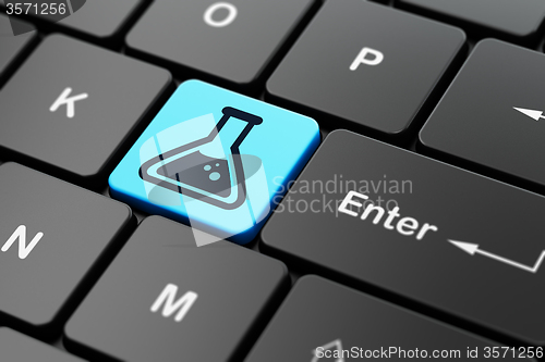 Image of Science concept: Flask on computer keyboard background