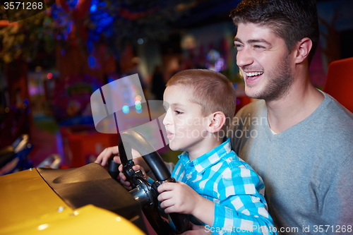 Image of father and son playing game in playground