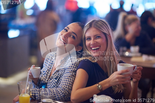 Image of girls have cup of coffee in restaurant