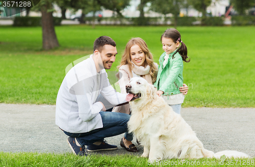 Image of happy family with labrador retriever dog in park