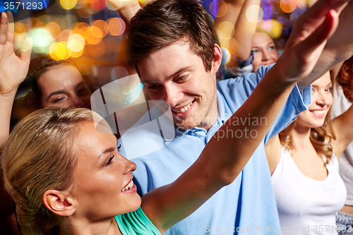 Image of happy couple having fun at music concert in club