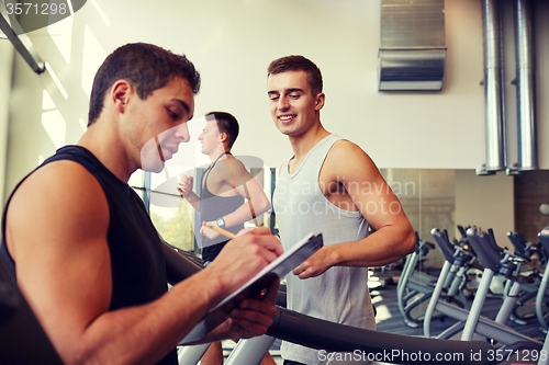 Image of men exercising on treadmill in gym