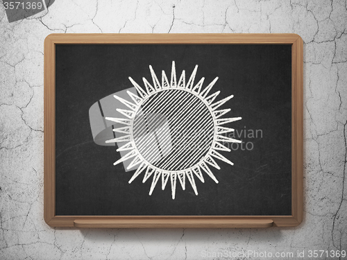 Image of Vacation concept: Sun on chalkboard background