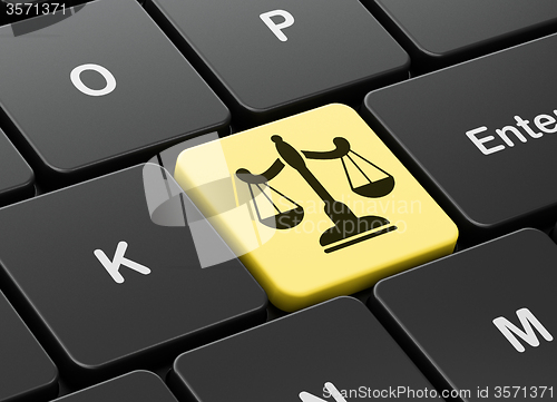 Image of Law concept: Scales on computer keyboard background