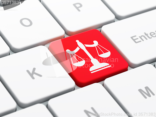 Image of Law concept: Scales on computer keyboard background