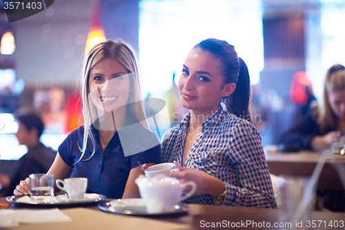 Image of girls have cup of coffee in restaurant