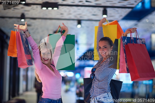 Image of happy young girls in  shopping mall