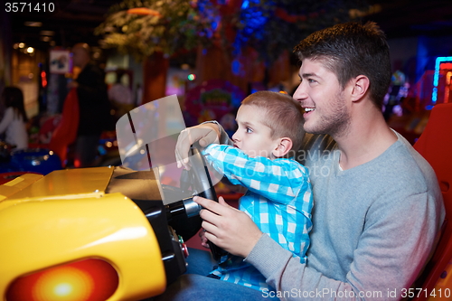 Image of father and son playing game in playground