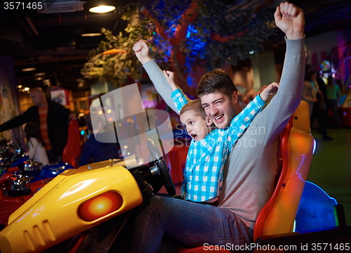 Image of father and son playing game in playground