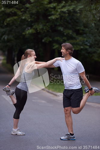 Image of jogging couple stretching