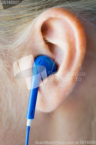 Image of close up of woman in earphones at home