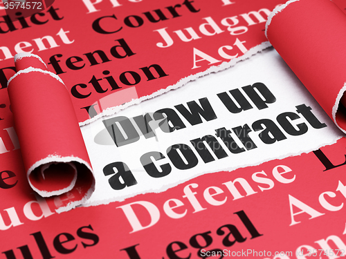 Image of Law concept: black text Draw up A contract under the piece of  torn paper