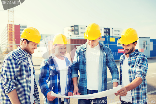 Image of group of builders with tablet pc and blueprint