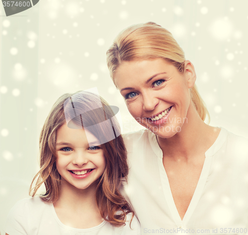 Image of smiling mother and little girl