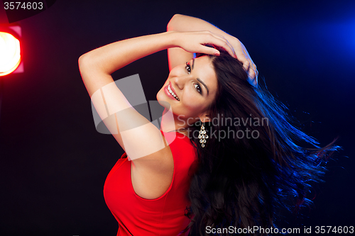 Image of beautiful sexy woman in red dancing at nightclub