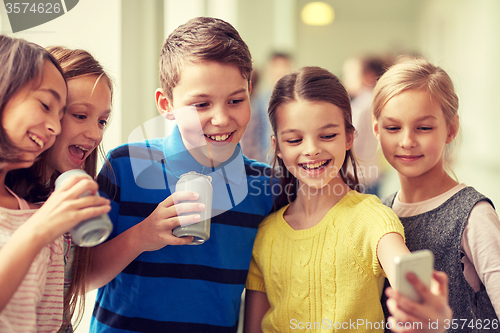 Image of group of school kids with smartphone and soda cans