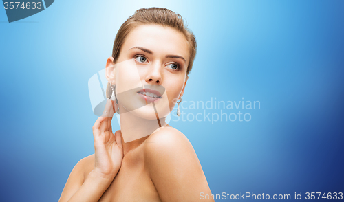 Image of beautiful woman with diamond earrings and bracelet