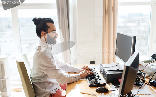 Image of happy creative male office worker with computer