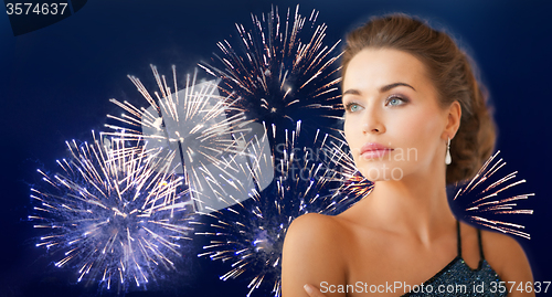 Image of beautiful woman wearing earrings over firework