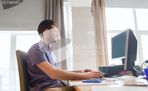 Image of happy creative male office worker with computer