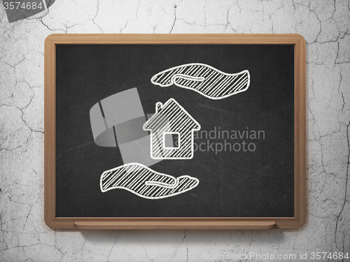Image of Insurance concept: House And Palm on chalkboard background