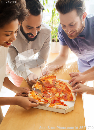 Image of happy business team eating pizza in office