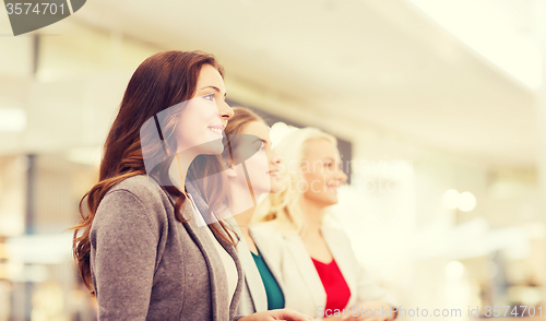 Image of happy young women in mall or business center