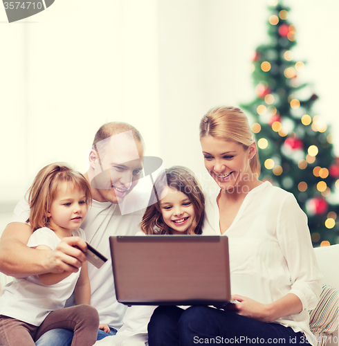 Image of happy family with laptop computer