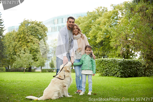 Image of happy family with labrador retriever dog in park