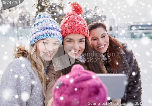 Image of happy teenage girls taking selfie with smartphone