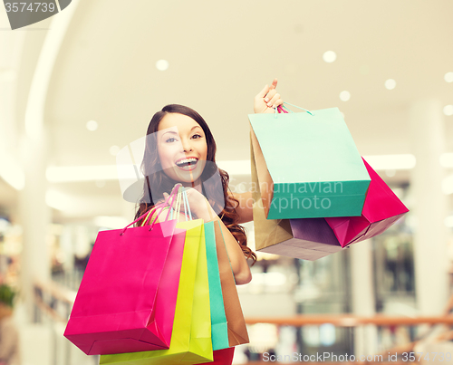 Image of smiling young woman with shopping bags