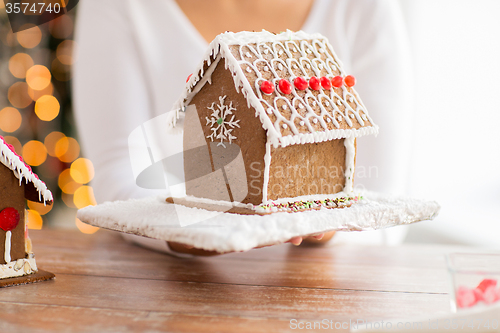 Image of close up of woman showing gingerbread house