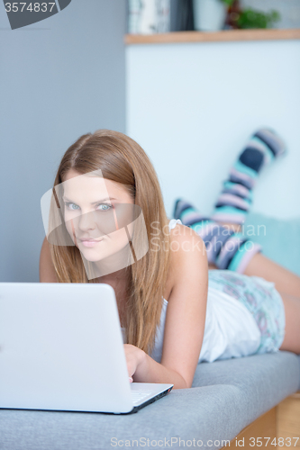 Image of Young woman using her laptop at home