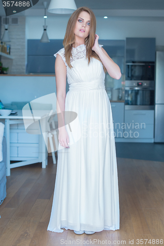 Image of Woman in Long White Dress Standing