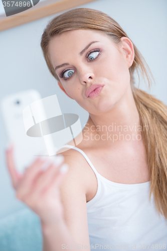 Image of Young woman pulling a face for selfie