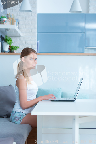 Image of Beautiful young woman working from home
