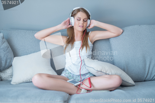 Image of Beautiful woman enjoying her music library