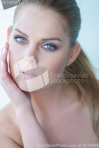 Image of Serious Young Woman with Hand on Chin