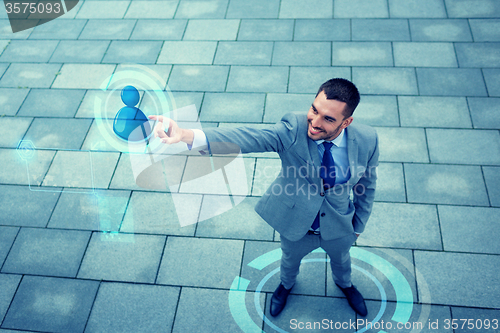 Image of young smiling businessman outdoors from top