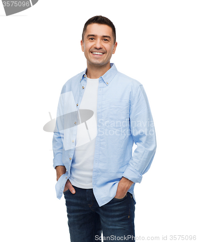 Image of smiling man with hands in pockets